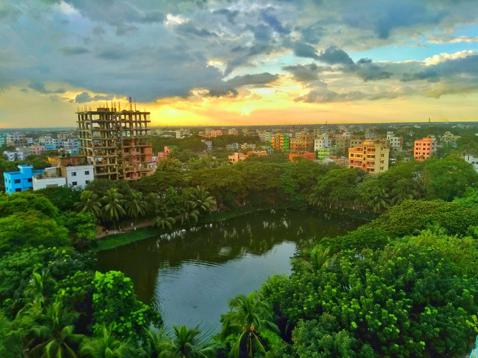 scenic-view-river-by-buildings-against-sky-sunset