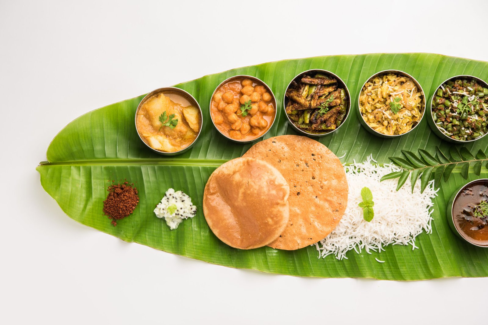 Traditional South Indian Meal or food served on big banana leaf, Food platter or complete thali. selective focus